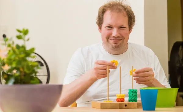 Mann macht fröhlich ein Steckspiel